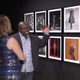 Kwame S. Brathwaite, right, discusses the work of his father, photographer Kwame Brathwaite with reporter Kemberly Richardson.
